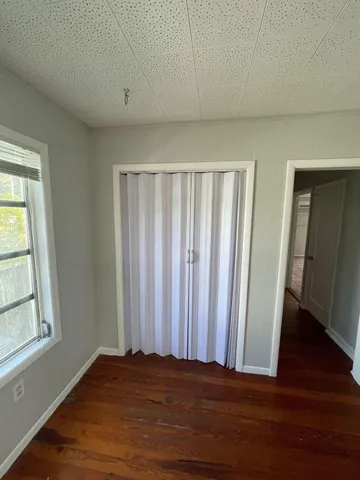 a view of wooden floor and windows in a room