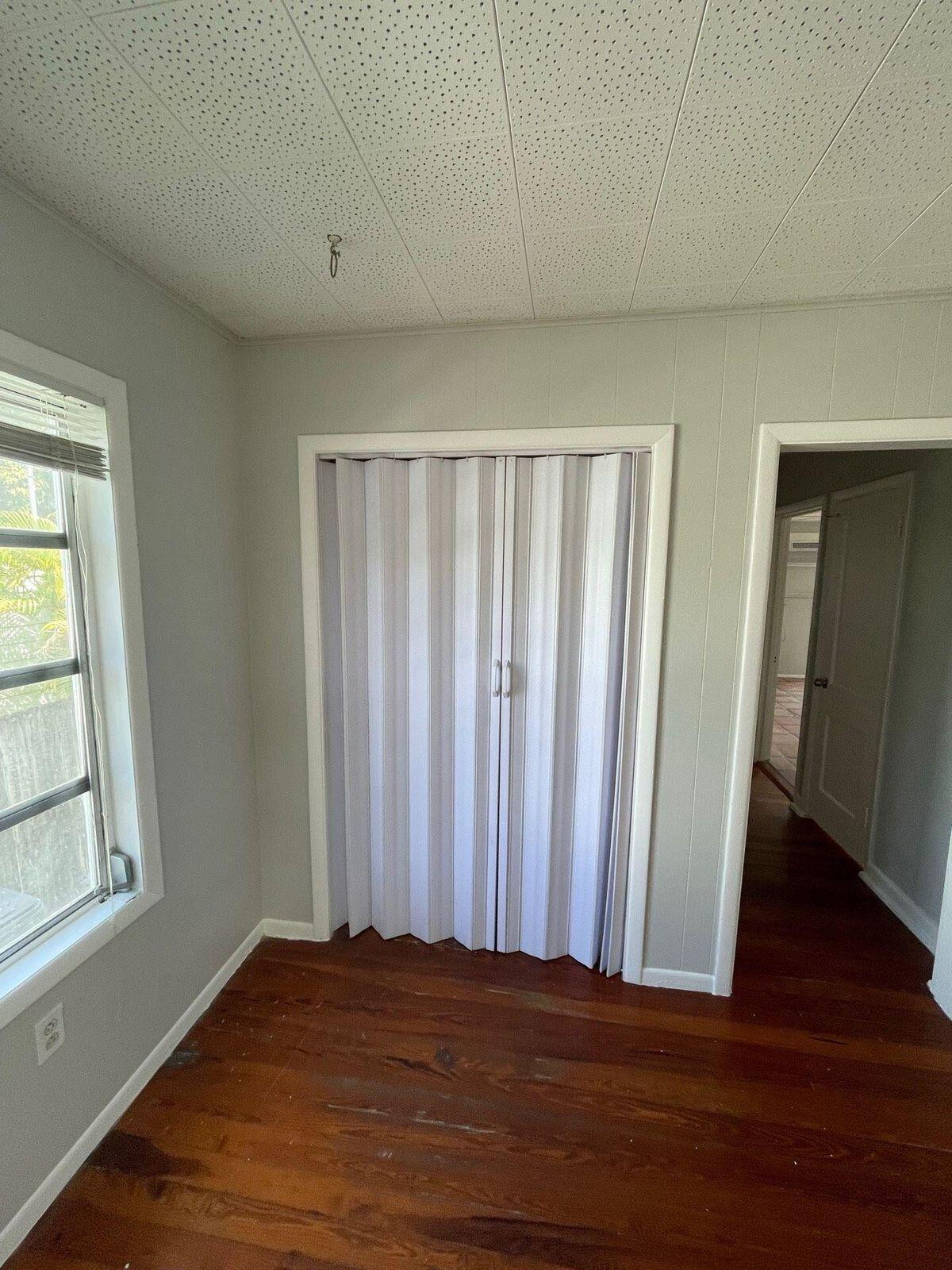 736 Omar Road, Unit 1 West Palm Beach, FL 33405 - Photo 21 of 25 a view of wooden floor and windows in a room