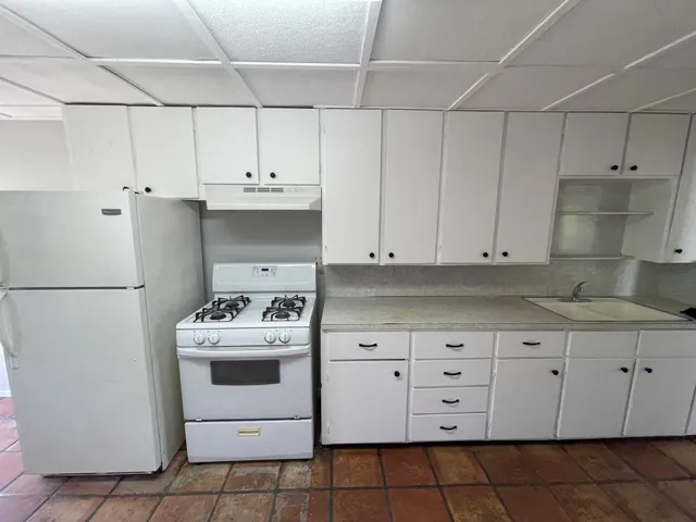 a kitchen with cabinets appliances and a sink