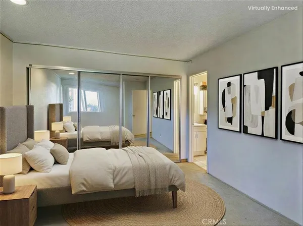 a bedroom with a bed couch and a window