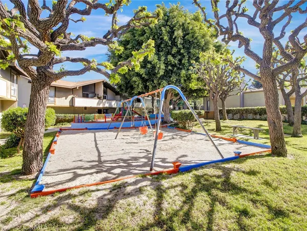 a view of outdoor space with playground and green space