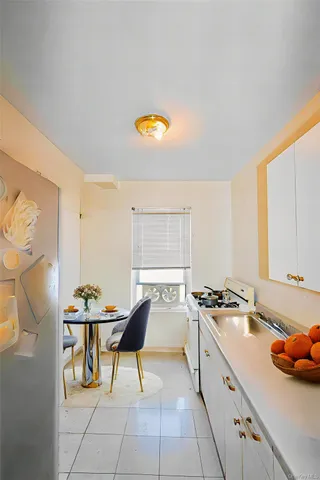 a kitchen with stainless steel appliances a stove a sink cabinets and a window