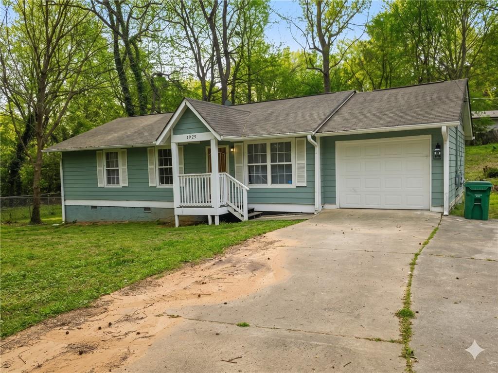 1929 Wee Kirk Road Southeast Atlanta, GA 30316 - Photo 21 of 22 a front view of a house with a garden and yard
