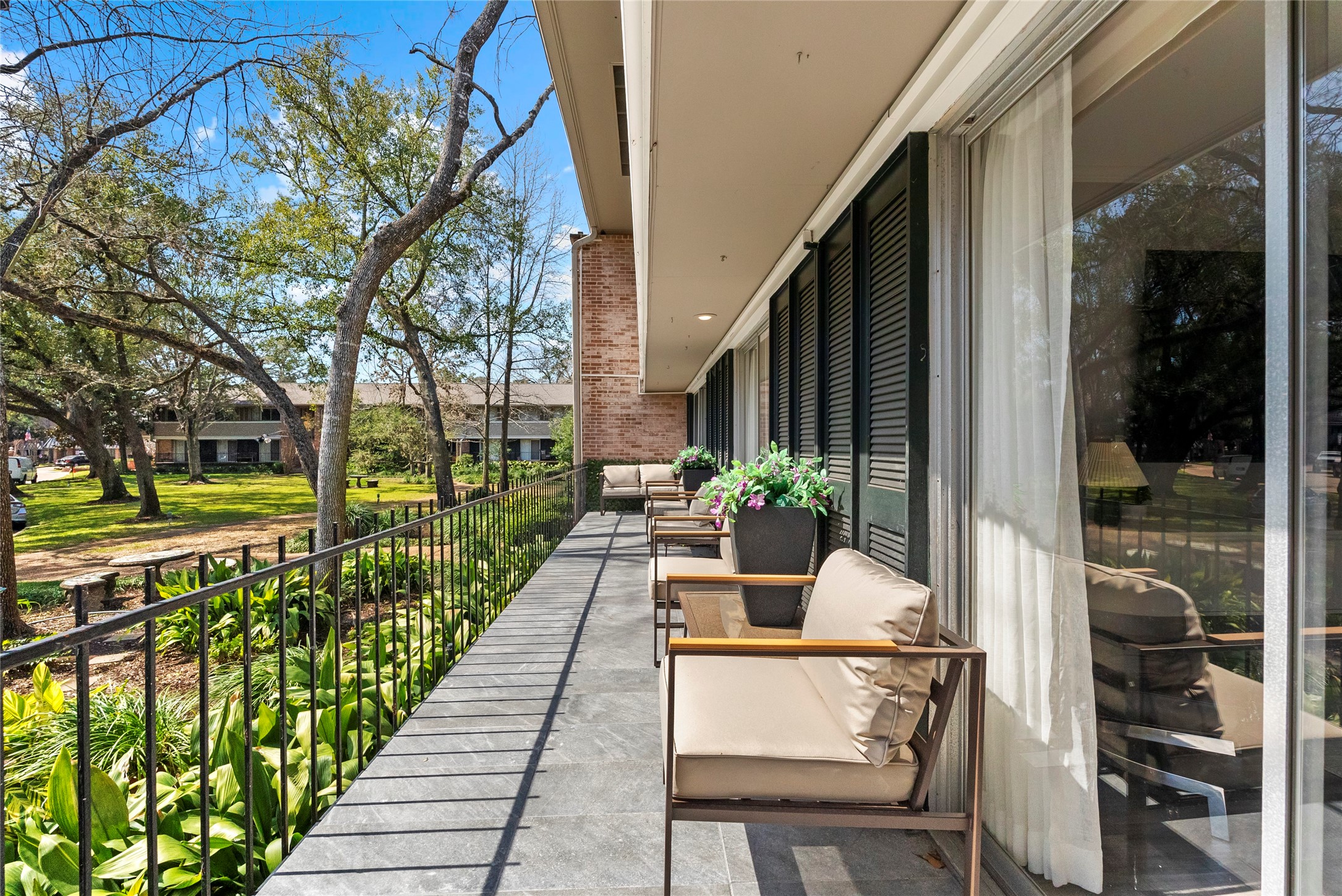 604 South Ripple Creek Drive, Unit 604 Houston, TX 77057 - Photo 1 of 31 a view of balcony with couple of trees and flowers