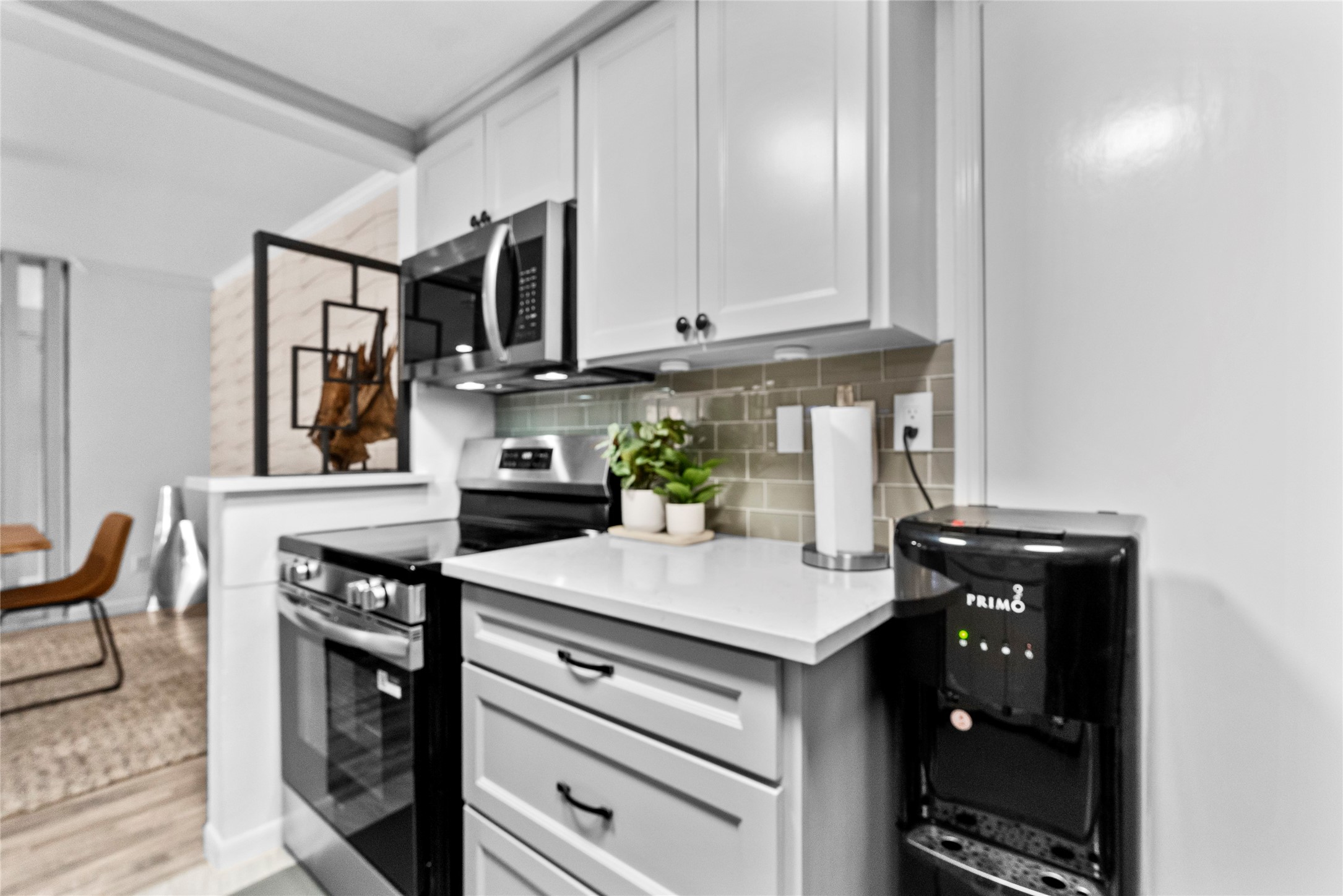 604 South Ripple Creek Drive, Unit 604 Houston, TX 77057 - Photo 11 of 31 a kitchen with stainless steel appliances granite countertop a stove a sink and a microwave