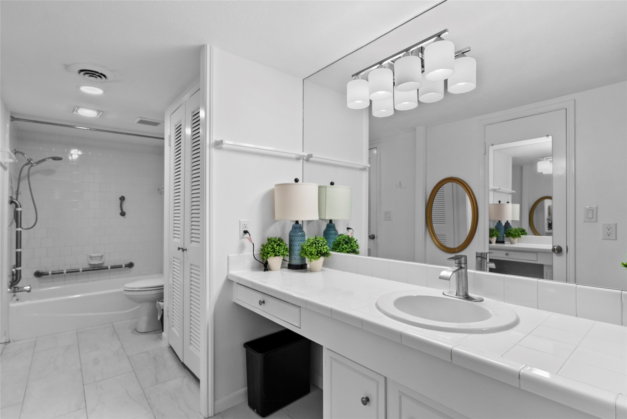 604 South Ripple Creek Drive, Unit 604 Houston, TX 77057 - Photo 18 of 31 a bathroom with a sink a toilet and a mirror