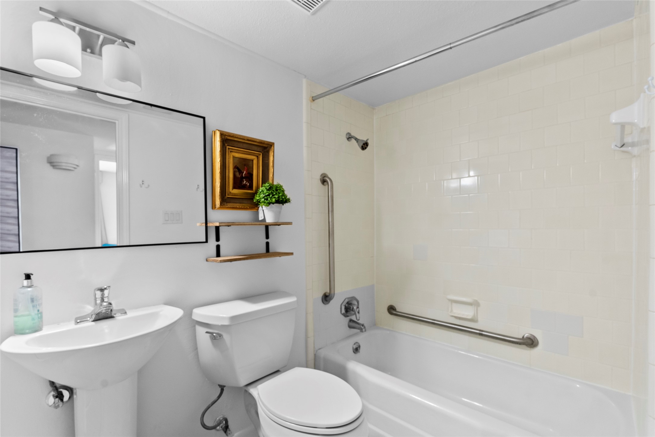 604 South Ripple Creek Drive, Unit 604 Houston, TX 77057 - Photo 25 of 31 a bathroom with a sink mirror toilet and vanity