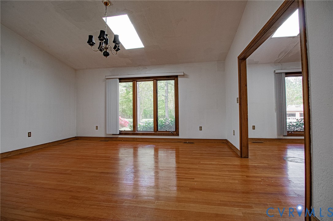10720 Kimages Road Charles City, VA 23030 - Photo 11 of 55 an empty room with wooden floor and windows