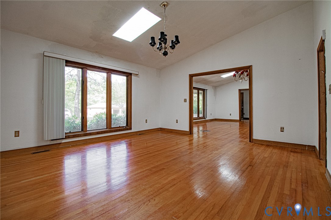 10720 Kimages Road Charles City, VA 23030 - Photo 12 of 55 a view of an empty room with wooden floor and a window