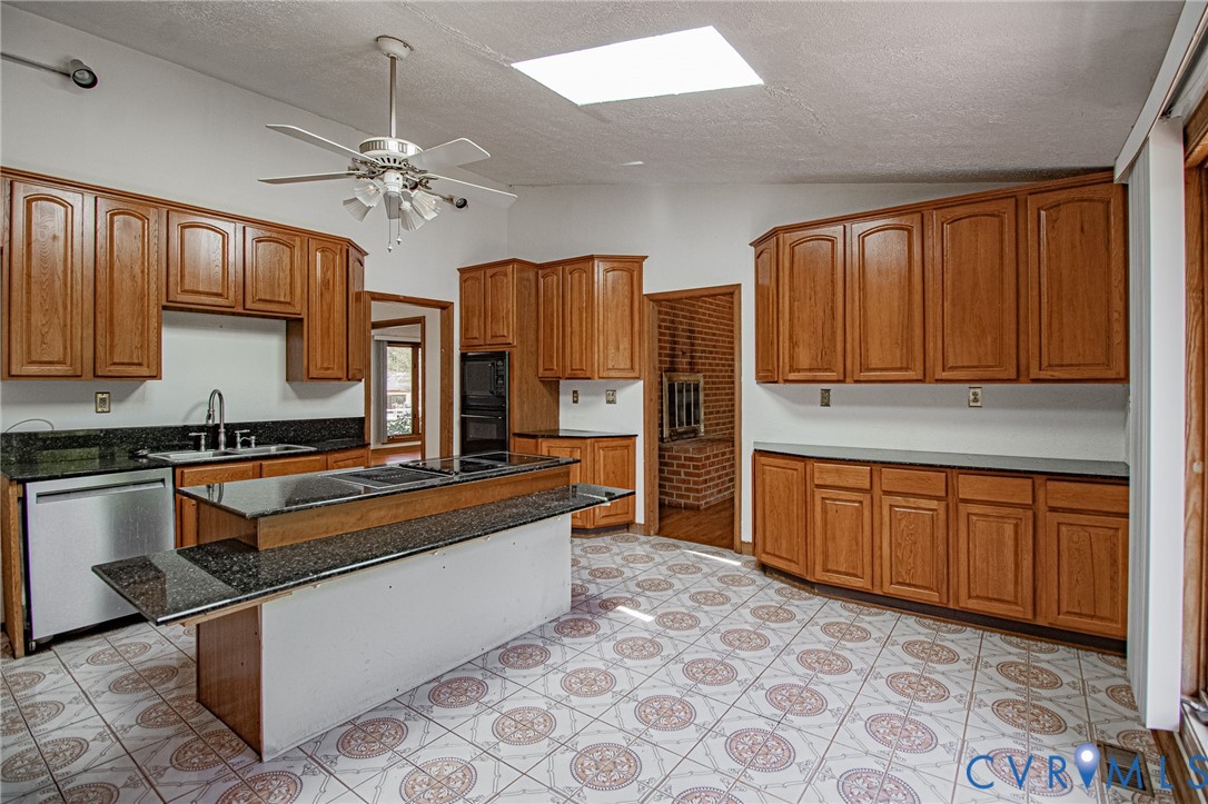 10720 Kimages Road Charles City, VA 23030 - Photo 17 of 55 a kitchen with stainless steel appliances granite countertop a stove refrigerator sink and cabinets