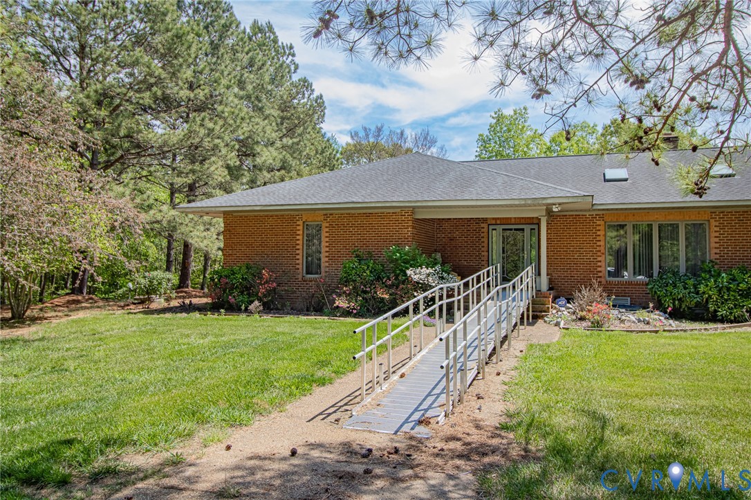 10720 Kimages Road Charles City, VA 23030 - Photo 3 of 55 a front view of a house with yard patio and green space