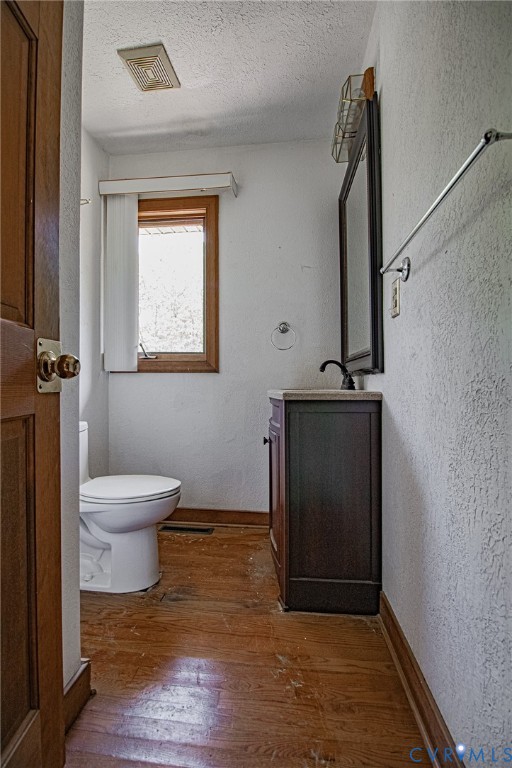 10720 Kimages Road Charles City, VA 23030 - Photo 37 of 55 a bathroom with a toilet a window and wooden floor