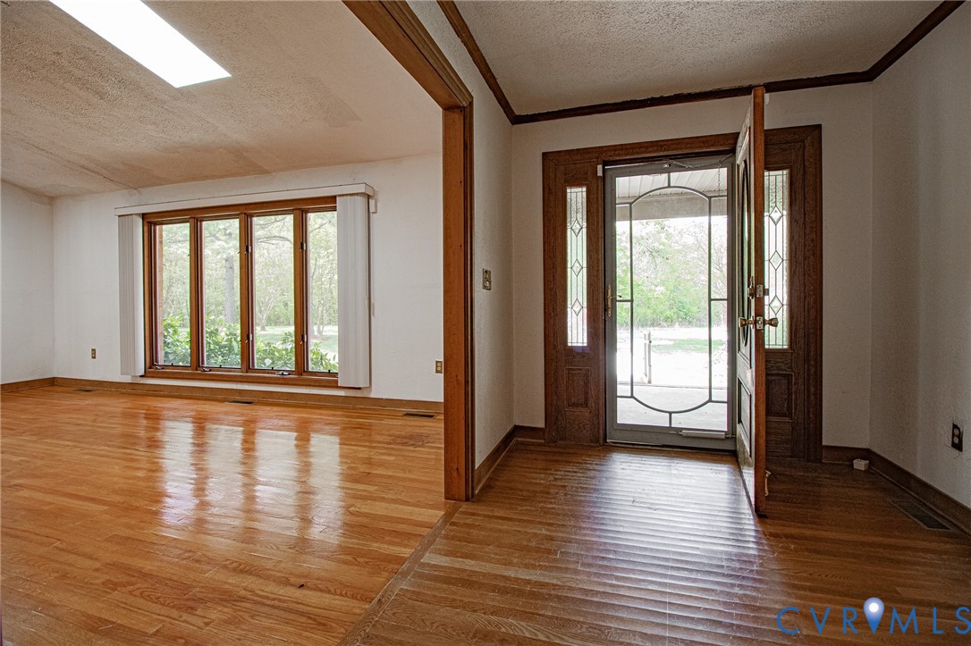 10720 Kimages Road Charles City, VA 23030 - Photo 7 of 55 a view of an empty room with wooden floor and a window