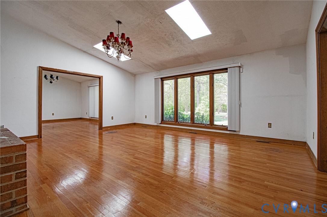 10720 Kimages Road Charles City, VA 23030 - Photo 9 of 55 a view of an empty room with wooden floor and a window