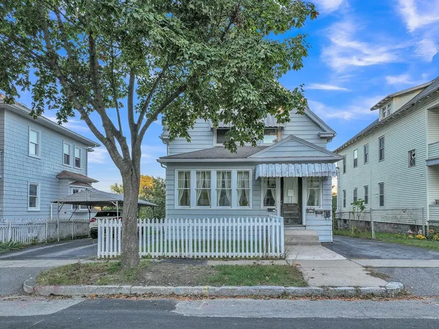 a front view of a house with a garden