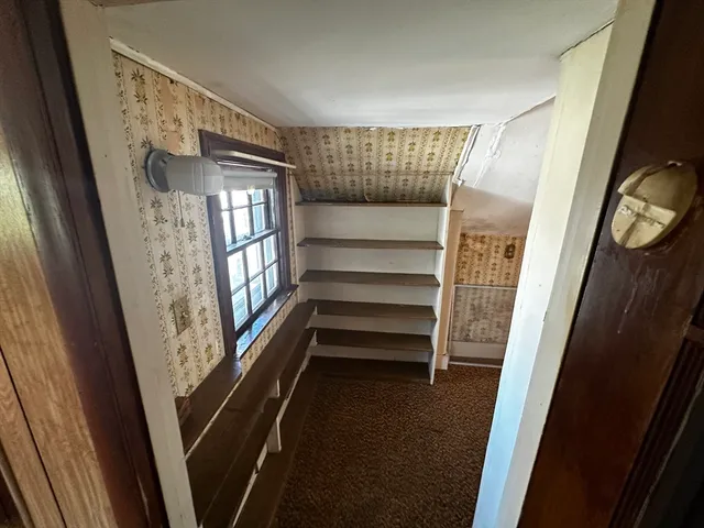 a view of walk in closet with empty racks