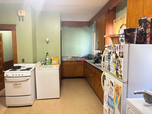 a kitchen with a stove top oven and cabinets