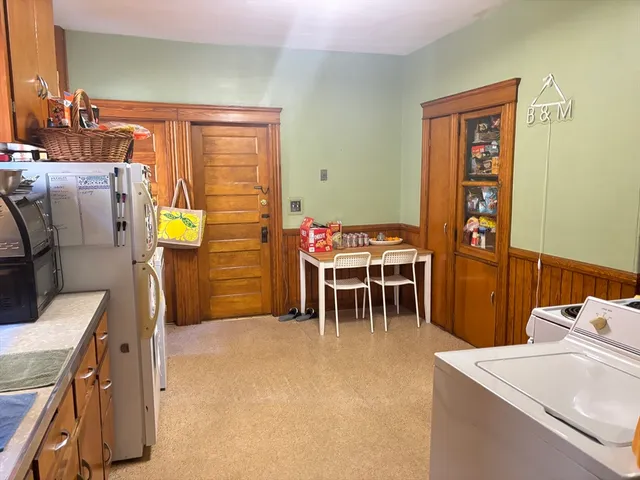 a dining room with furniture and a window