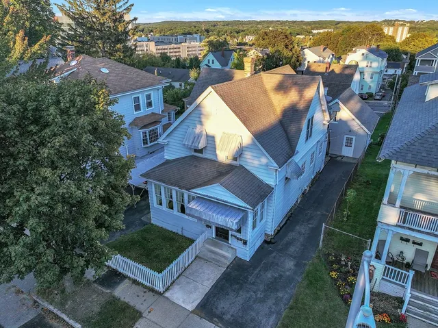an aerial view of a house with a yard lake view and mountain view