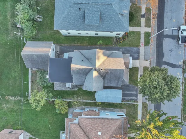 an aerial view of a house with a garden and a yard