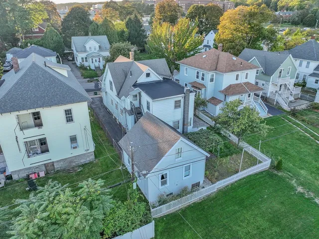 an aerial view of a house with garden space and street view