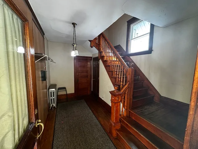 a view of entryway and hall with wooden floor