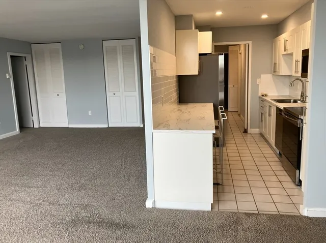 a kitchen with stainless steel appliances a refrigerator and a stove top oven