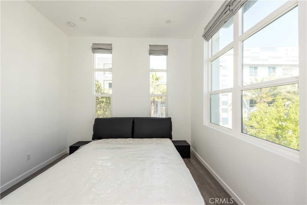 2208 Synergy Irvine, CA 92614 - Photo 11 of 22 a bedroom with a bed and a window