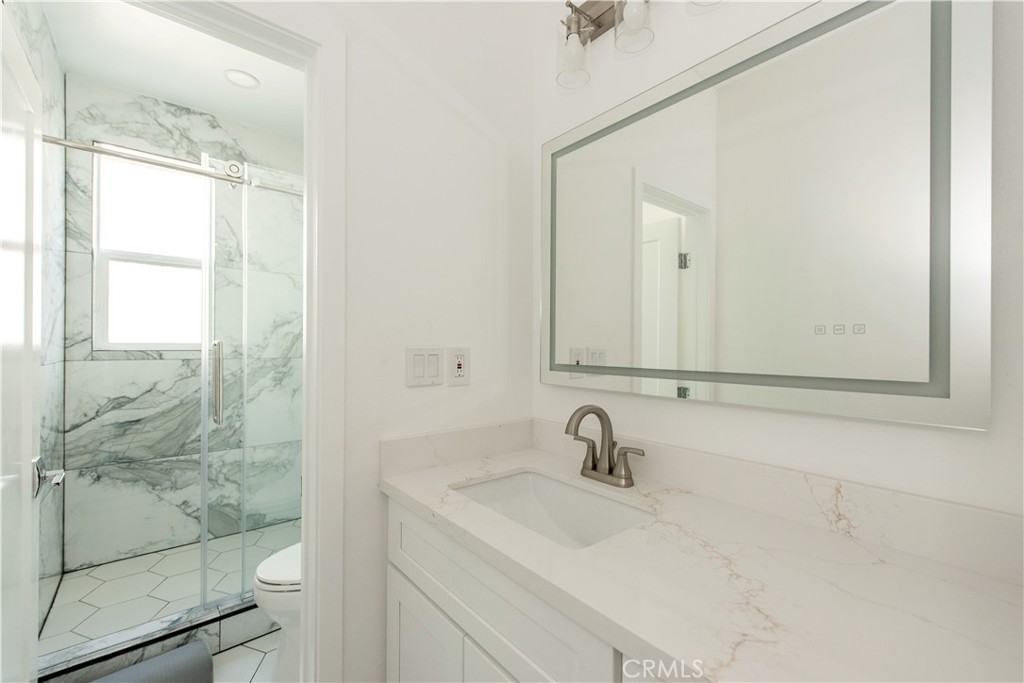 2208 Synergy Irvine, CA 92614 - Photo 16 of 22 a bathroom with a sink and a mirror