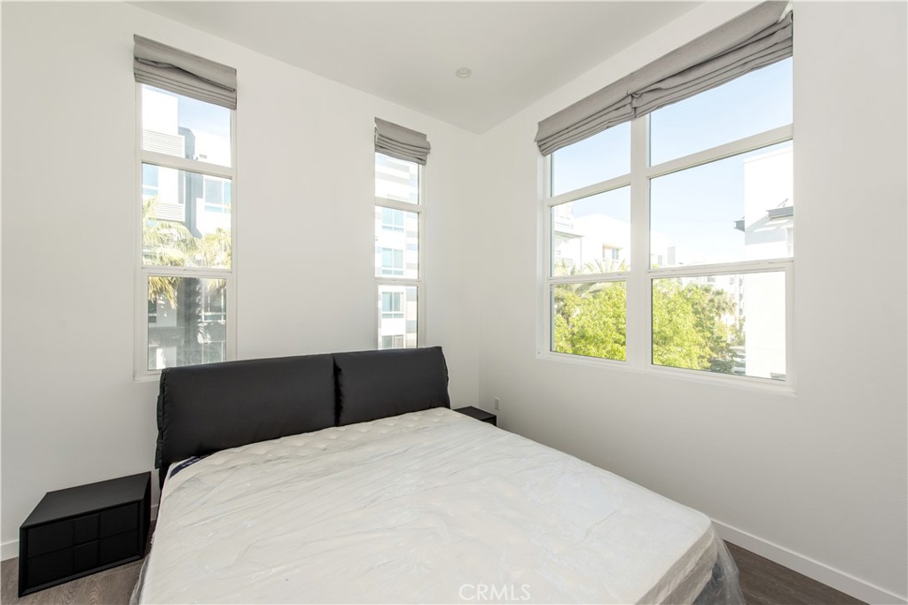 2208 Synergy Irvine, CA 92614 - Photo 10 of 22 a black bed sitting in a bedroom next to a window