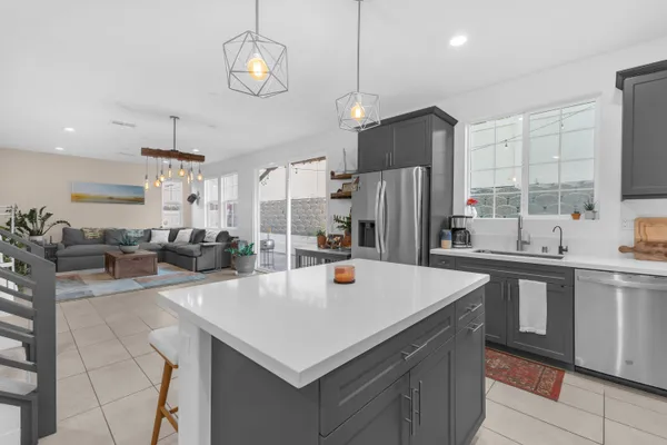 a kitchen with refrigerator cabinets and a sink
