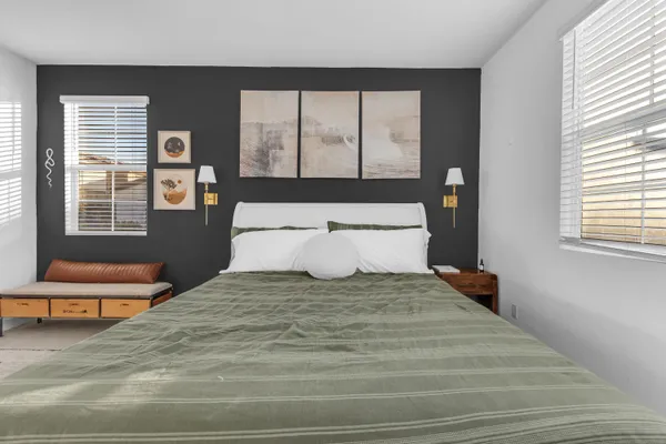 a bedroom with a large bed and a window