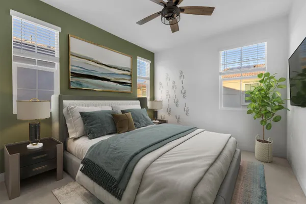 a bedroom with a bed and a potted plant