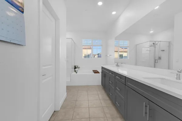 a spacious bathroom with a granite countertop sink a toilet mirror and bathtub