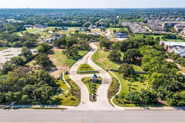 an aerial view of residential house with yard and ocean view