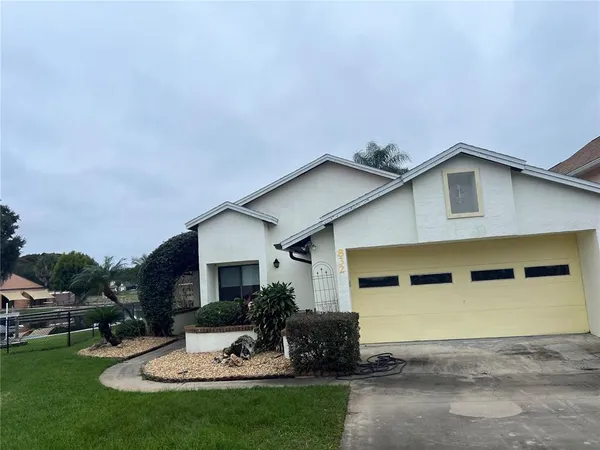 a front view of a house with a garden and patio