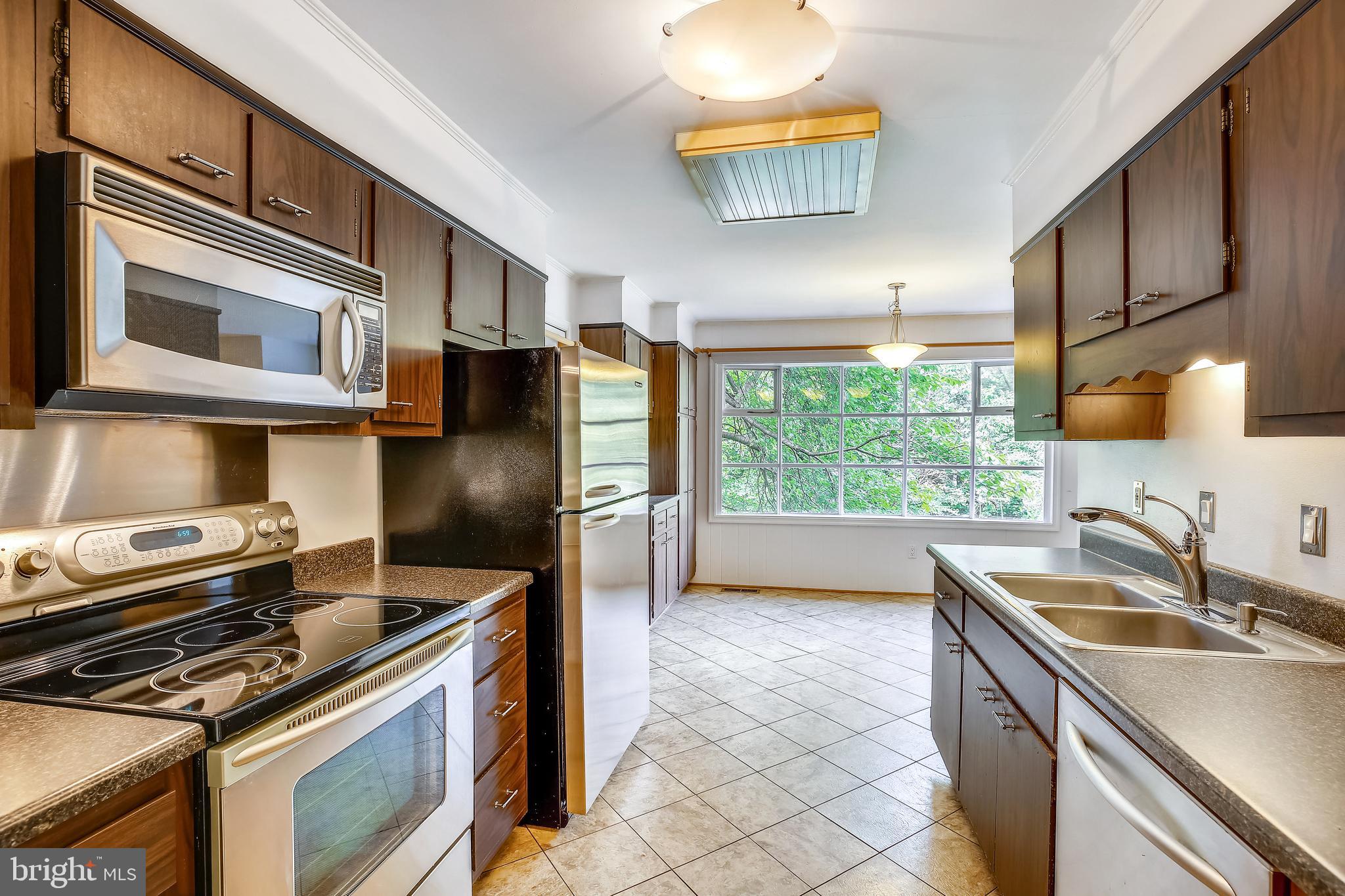 9505 Emory Grove Road Gaithersburg, MD 20877 - Photo 22 of 75 a kitchen with stainless steel appliances granite countertop a sink stove and refrigerator