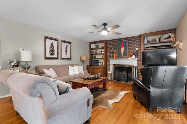 a living room with furniture fireplace and flat screen tv