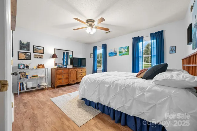 a bedroom with a bed furniture and a chandelier