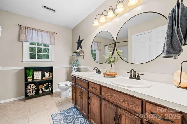 a bathroom with a double vanity sink and a mirror