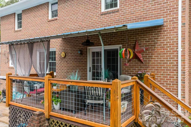 a view of a brick house with large windows