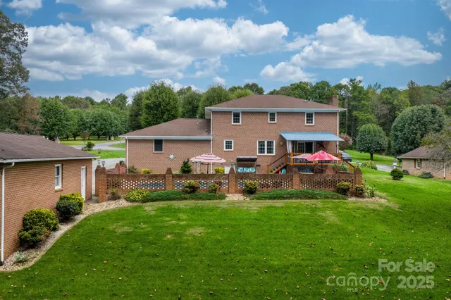 a view of a house with a yard and sitting area
