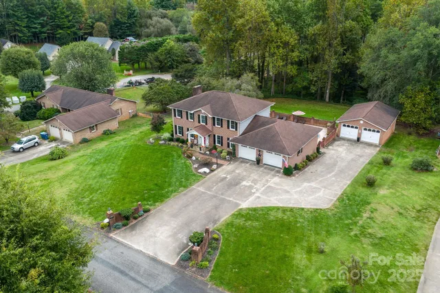 an aerial view of a house with a garden and a yard