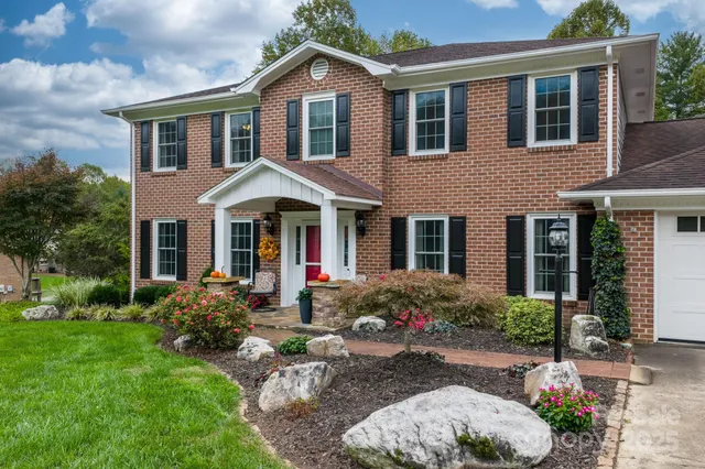 a front view of a house with garden and porch
