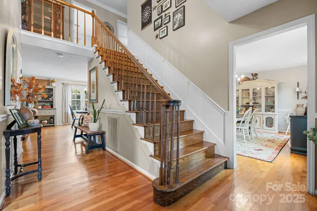 a view of entryway and hall with wooden floor