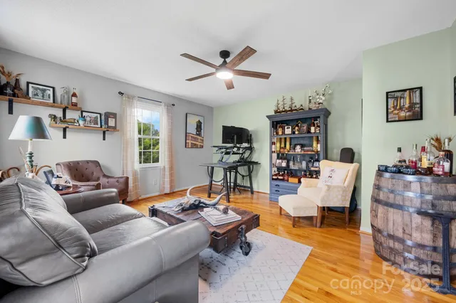 a living room with furniture and wooden floor