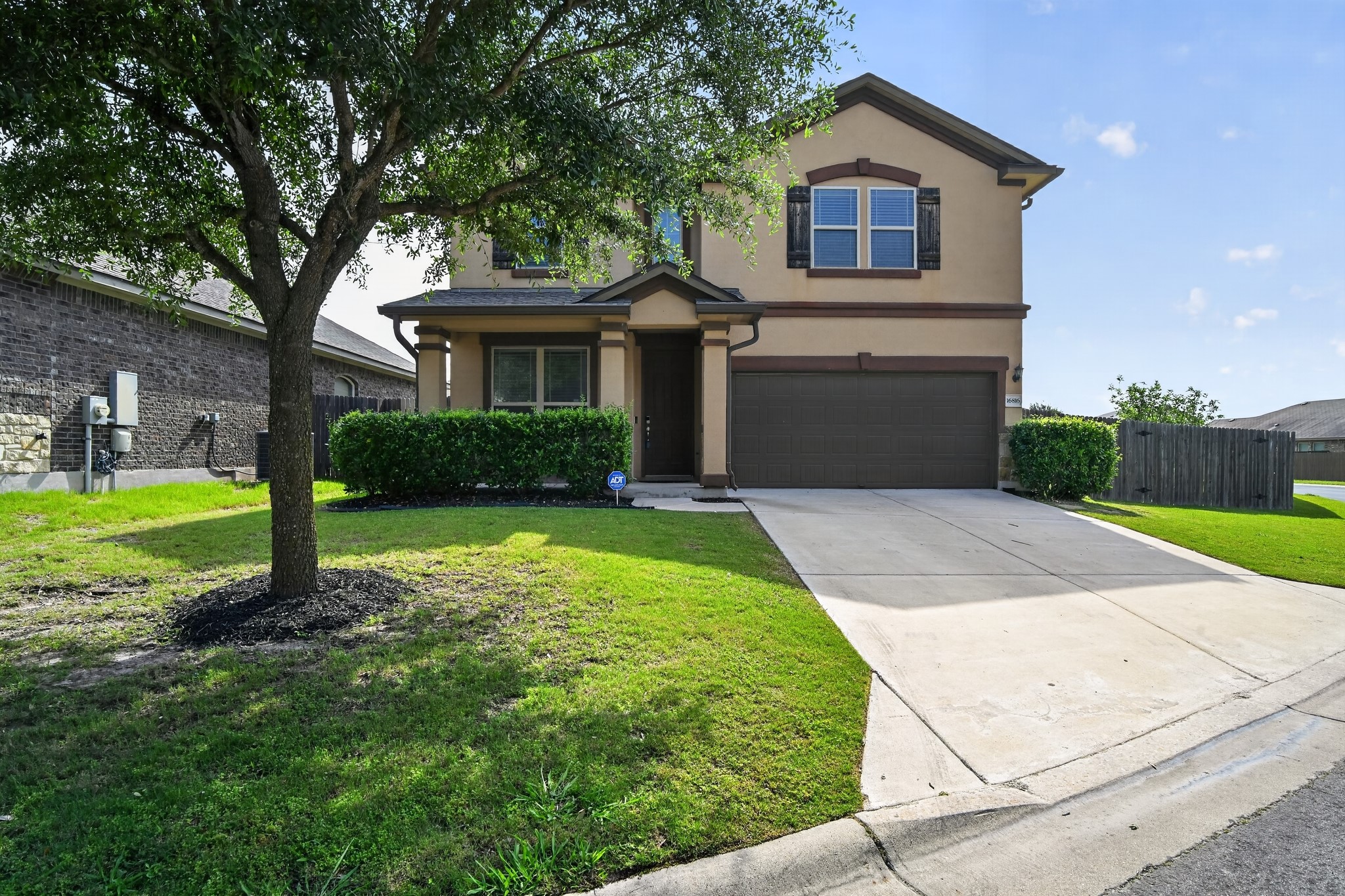 16816 Ruggio Road Pflugerville, TX 78660 - Photo 2 of 30 A welcoming facade with a neat concrete driveway and well-kept green lawn.