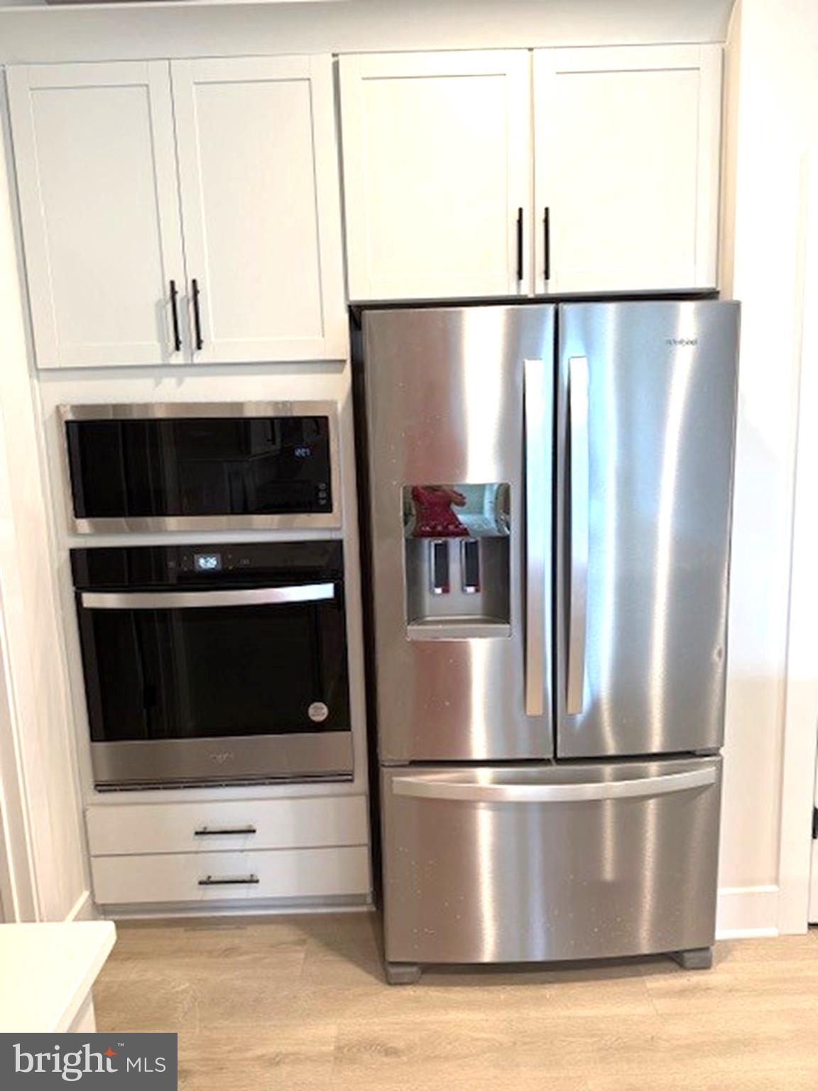 163 Merrick Way Ocean View, DE 19970 - Photo 3 of 10 a metallic refrigerator freezer sitting in a kitchen
