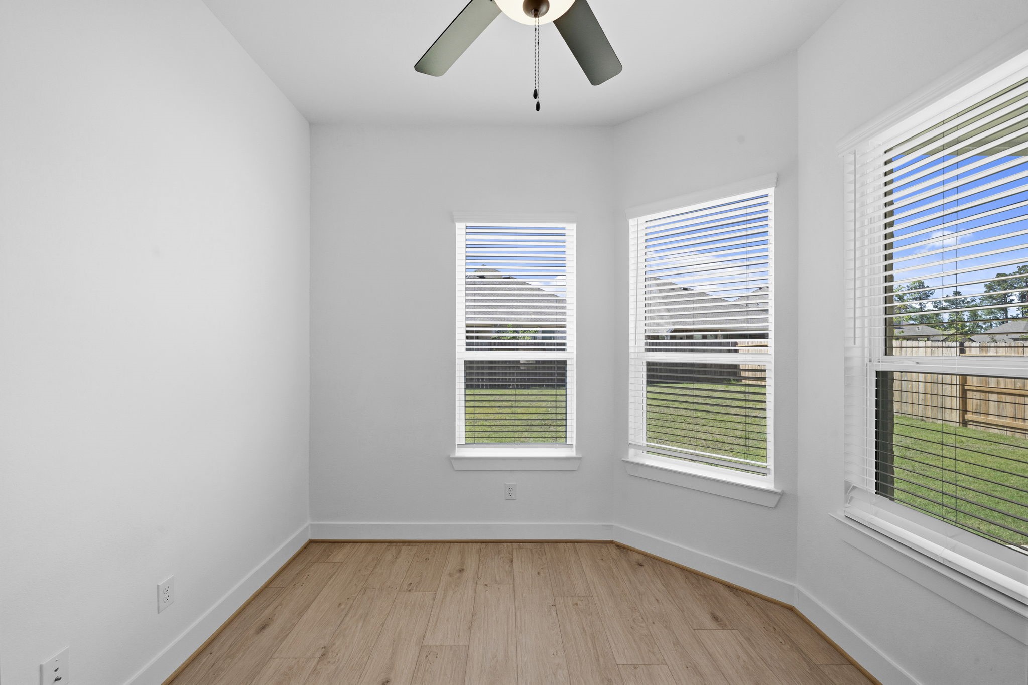 18103 Scarlett Hummingbird Court Conroe, TX 77302 - Photo 11 of 43 a view of an empty room with a window and wooden floor