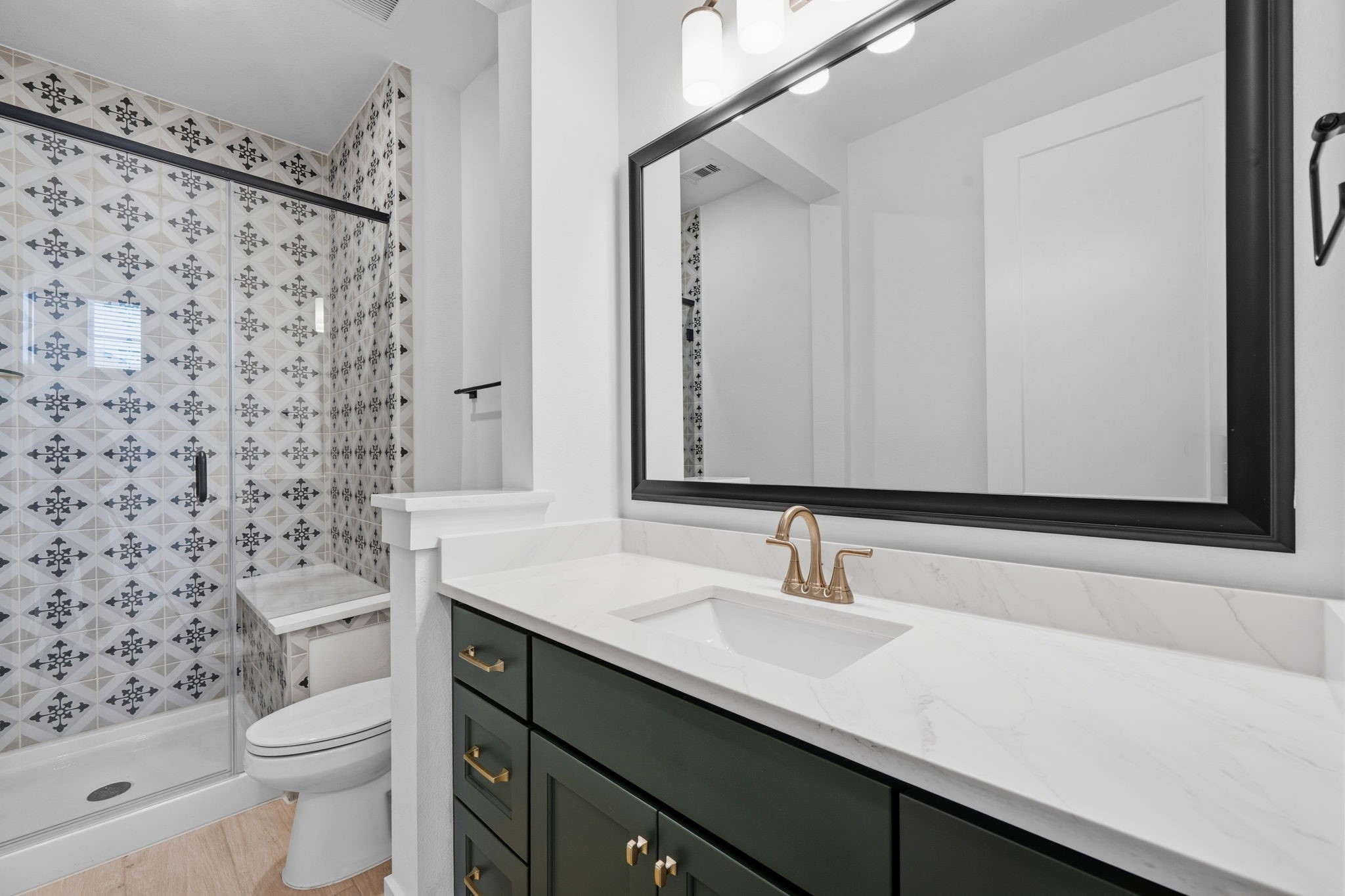 18103 Scarlett Hummingbird Court Conroe, TX 77302 - Photo 12 of 43 a bathroom with a sink a toilet and shower curtain